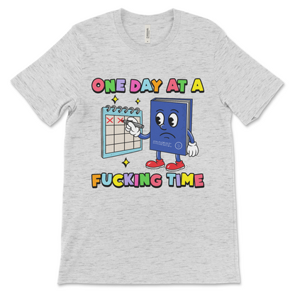 12 step meme shirt that says one day at a fucking time featuring an AA big book or NA big book